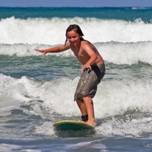 A young caucasian male learns to surf on Whangaehu Beach, Central Hawkes Bay, New Zealand