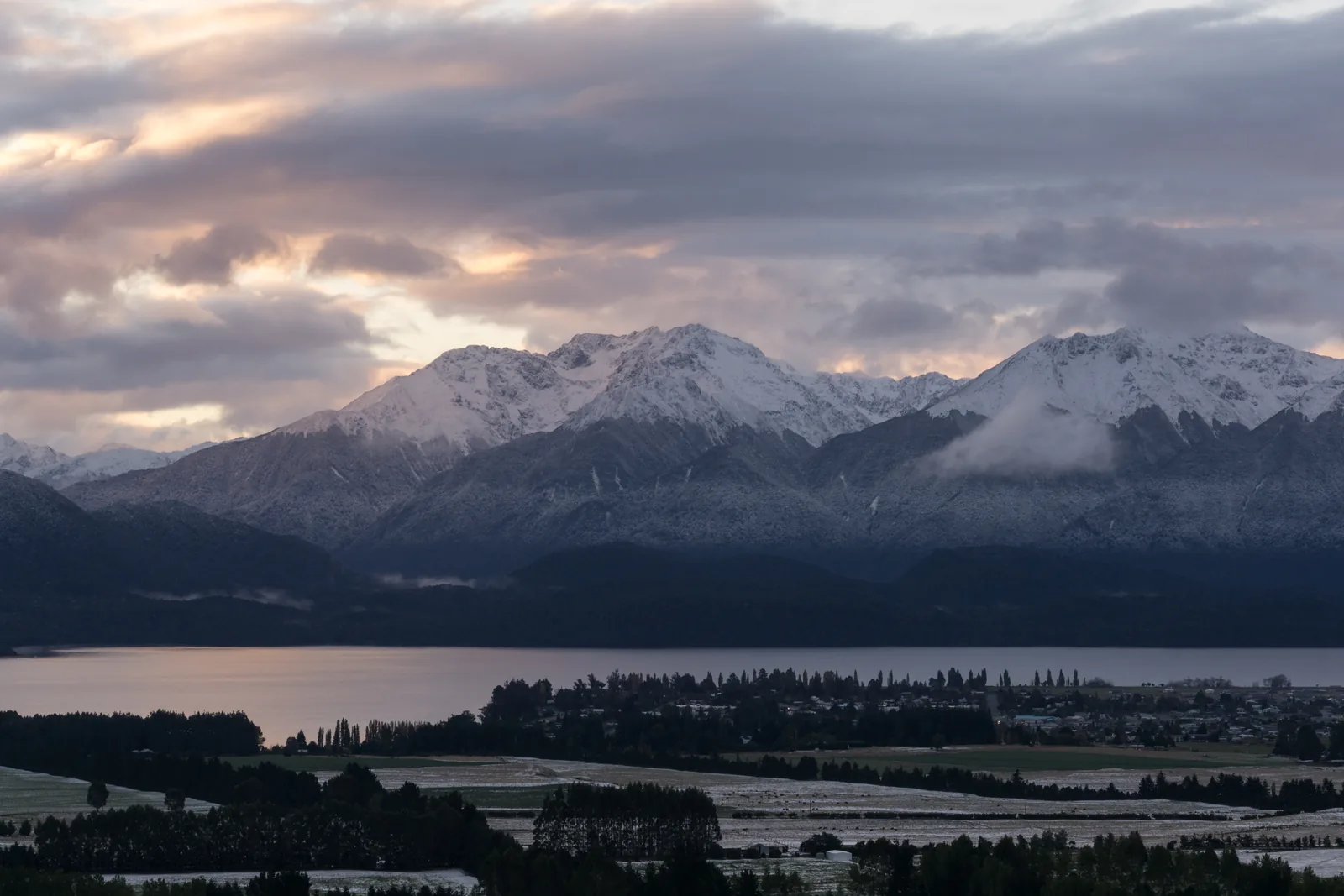 Te Anau beneath the Murchison Mountains at dusk.