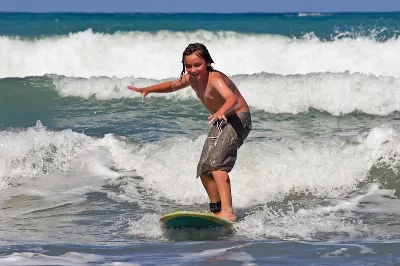 A Young Caucasian Male Learns To Surf On Whangaehu Beach, Central Hawkes Bay, New Zealand
